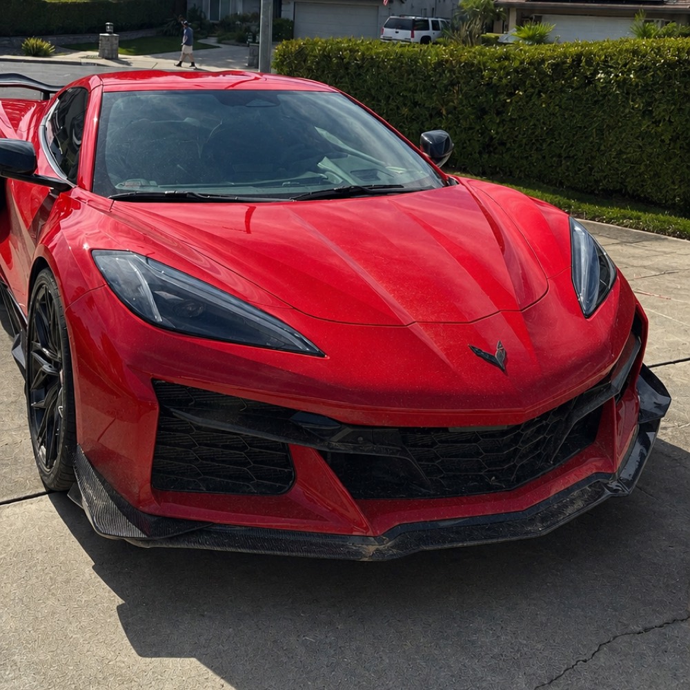Before — red Corvette Z06 dulled by road dust and water spotting